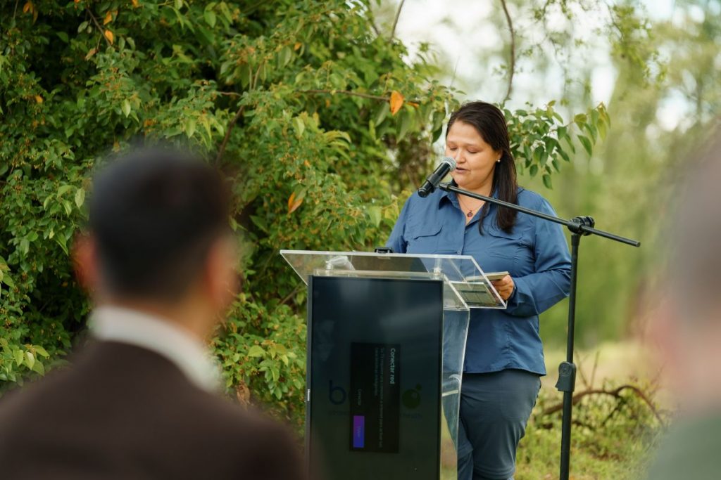 Camila Figueroa speaking at the inauguration of BENEO’s reforestation project in Chile, outdoors among trees.