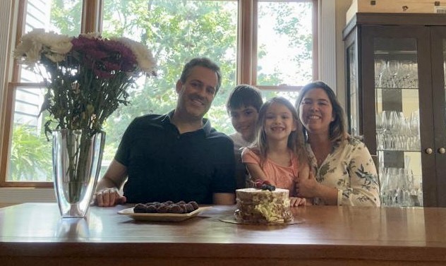 Juliana and her family gathered around the kitchen counter in their new home.